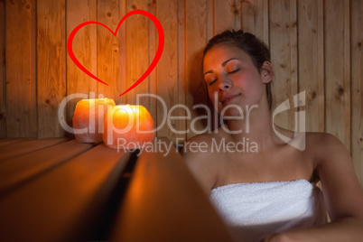 Composite image of happy brunette woman sitting in a sauna