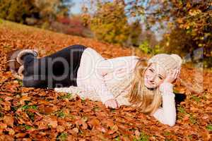 young woman outdoor in autumn warm clothes