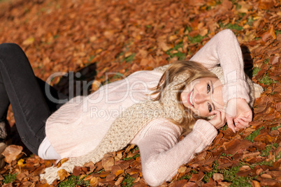 young smiling woman with hat and scarf outdoor in autumn