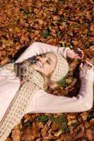 young smiling woman with hat and scarf outdoor in autumn