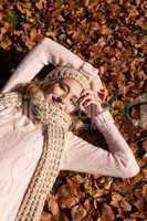 young smiling woman with hat and scarf outdoor in autumn