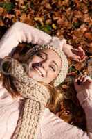 young smiling woman with hat and scarf outdoor in autumn
