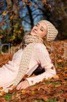 young smiling woman with hat and scarf outdoor in autumn