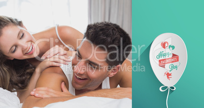 Composite image of romantic young couple in bed at home Composite image of romantic young couple in bed at home