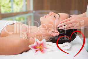 Composite image of attractive woman receiving head massage at sp