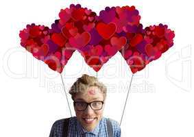 Composite image of geeky hipster covered in kisses