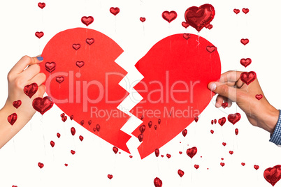 Composite image of two hands holding broken heart