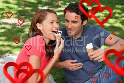 Composite image of woman eating ice cream while sitting with her