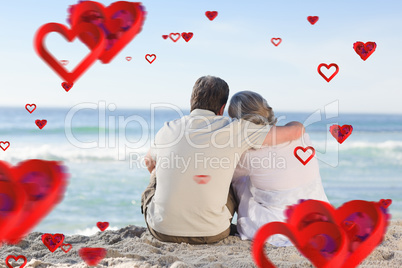 Composite image of senior couple looking at the sea