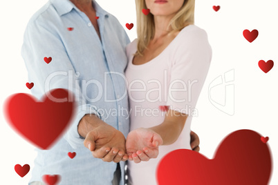Composite image of happy couple holding their hands out Composite image of happy couple holding their hands out