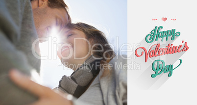Composite image of cute couple hugging in the park