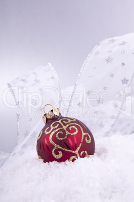 beautiful gold and red christmas decoration on white snow