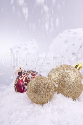 beautiful gold and red christmas decoration on white snow