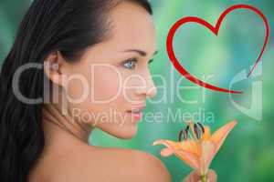 Composite image of beautiful nude brunette smelling lily