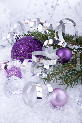 beautiful christmas decoration in purple and silver on white snow