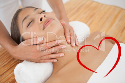 Composite image of beautiful brunette enjoying a head massage