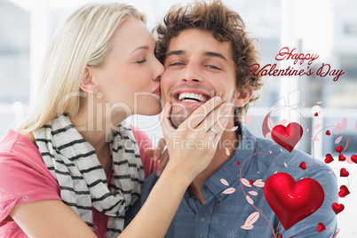 Composite image of woman kissing man on his cheek