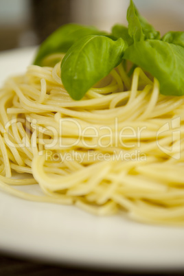 tasty fresh pasta with garlic and basil on table