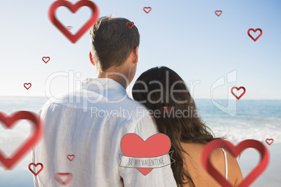 Composite image of peaceful couple looking at the ocean