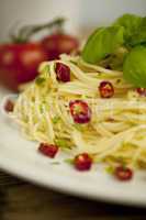 fresh pasta with basil and red chilli on table