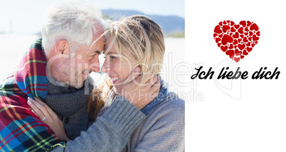 Composite image of happy married couple embracing on the beach