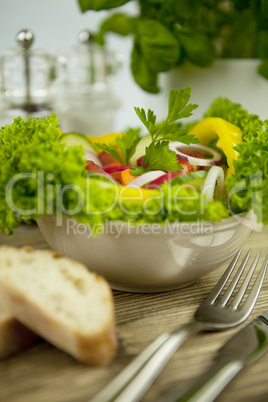 fresh tasty healthy mixed salad and bread on table