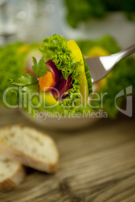 fresh tasty healthy mixed salad and bread on table