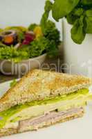 fresh tasty club sandwich with cheese and ham on table
