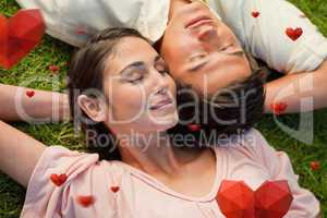 Composite image of man and a woman lying head to shoulder with t