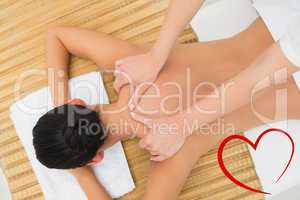 Composite image of peaceful brunette enjoying a shoulder massage