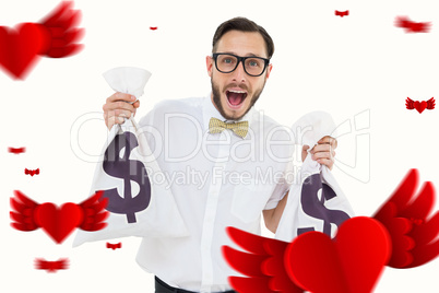 Composite image of geeky businessman holding money bags