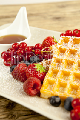 fresh tasty waffer with powder sugar and mixed fruits