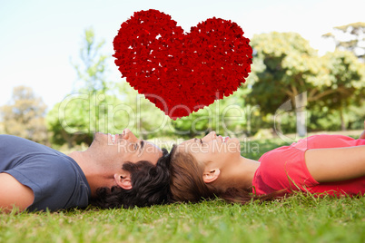 Composite image of two smiling friends looking upwards while lyi