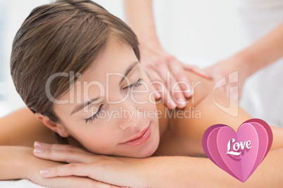 Composite image of attractive woman receiving back massage at sp