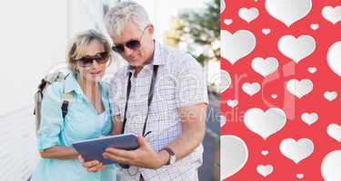 Composite image of happy tourist couple using tablet in the city
