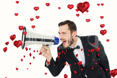 Composite image of geeky businessman shouting through megaphone