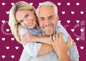 Composite image of happy couple standing and hugging