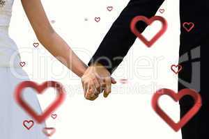 Composite image of mid section of newlywed couple holding hands