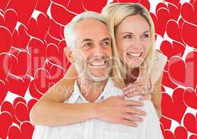 Composite image of happy man giving his partner a piggy back