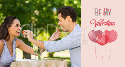 Composite image of couple feeding strawberries to each other at