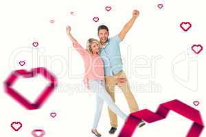 Composite image of attractive couple smiling and cheering