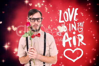 Composite image of geeky hipster offering a rose