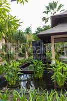 Ornate column in formal Balinese garden