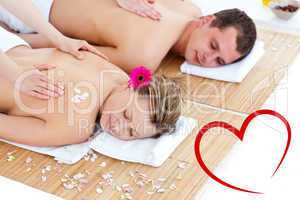 Composite image of beautiful young couple receiving a back massa