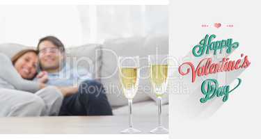 Composite image of couple resting on a couch with flutes of cham