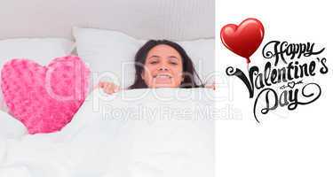 Composite image of woman lying in bed next to a fluffy heart pil