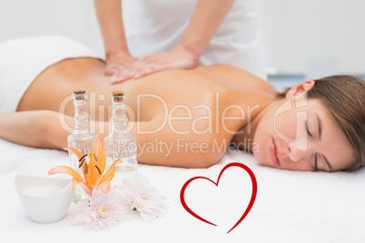 Composite image of attractive woman receiving back massage at sp