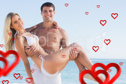 Composite image of man carrying his pretty girlfriend smiling at