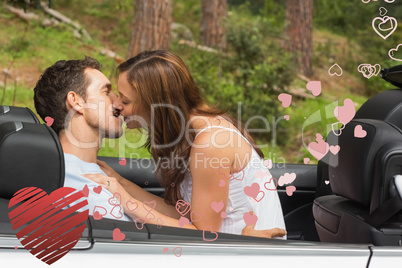 Composite image of young couple smooching on the backseat