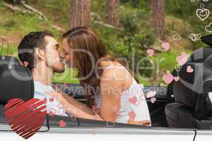 Composite image of young couple smooching on the backseat